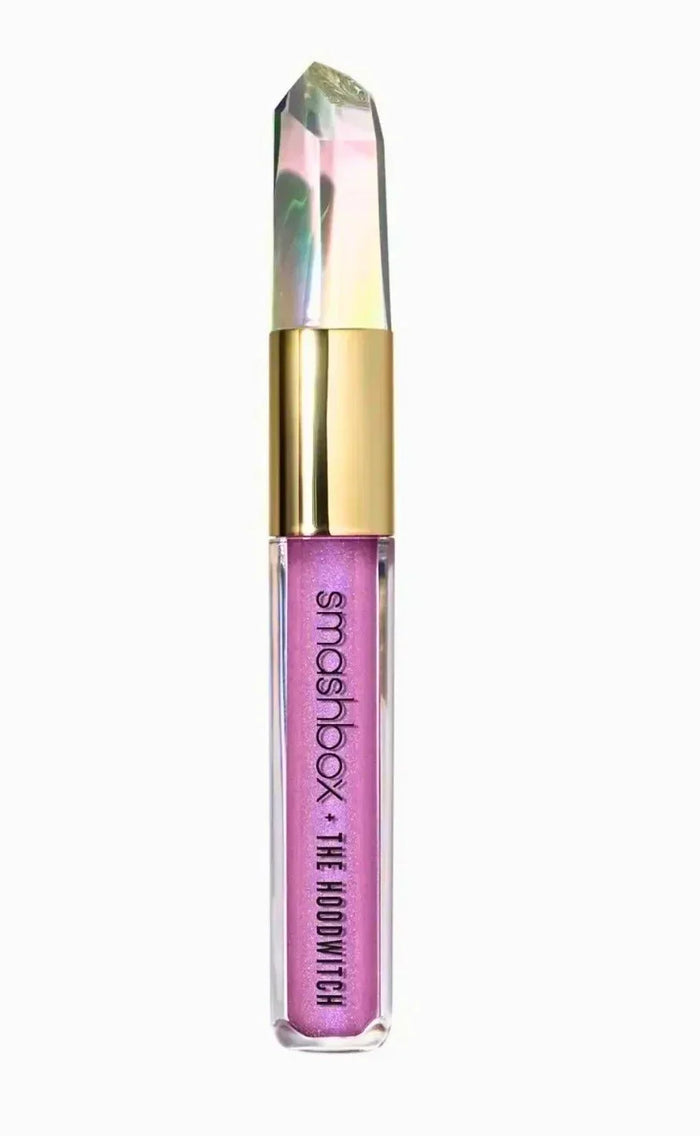 Iridescent pink glitter eyeshadow in a clear tube with gold cap and prism crystal top
