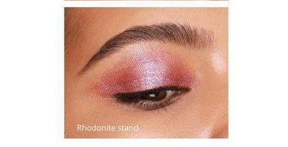 Close-up of eyelid with pink shimmer eyeshadow labeled Rhodonite Stand