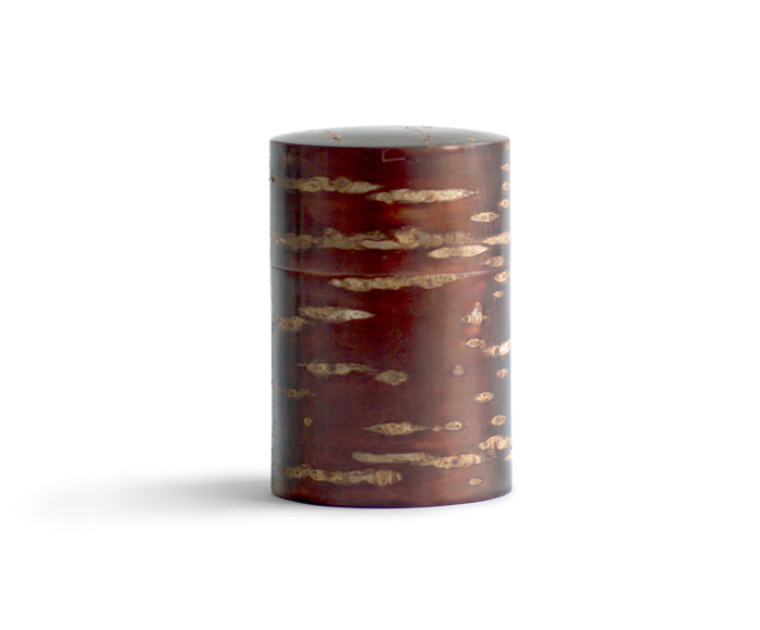 Silhouetted image of tall Smooth Cherry Bark Tea Canister by Denshiro against white background.