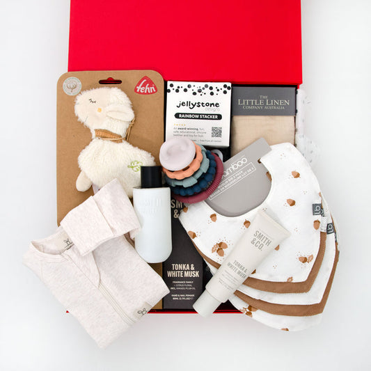 thoughtful gender neutral hamper including romper, crinkle toy, silicone stack toy, muslin wrap, 6 pack bibs, hand cream and room spray. From $195.00