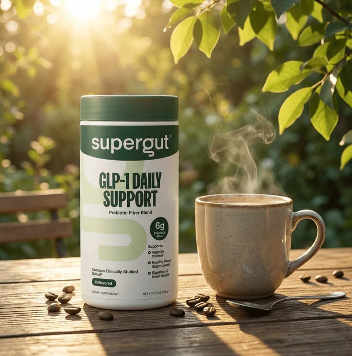 Supergut GLP-1 Daily Support prebiotic fiber powder unflavored on outdoor table with coffee mug
