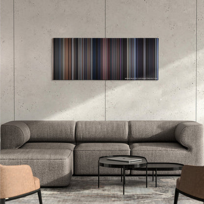 The Fly color palette canvas on a concrete wall above a gray sectional sofa