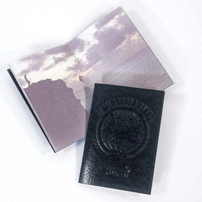 Two "The Wonder Years" books are shown: one open to a cliff-jumping sunset photo, the other closed with a black embossed cover featuring a globe and text.