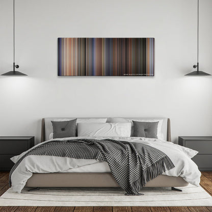 Twister color palette canvas above a bed, between two black pendant lamps