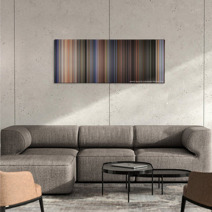 Twister color palette canvas on a concrete wall above a gray sectional sofa