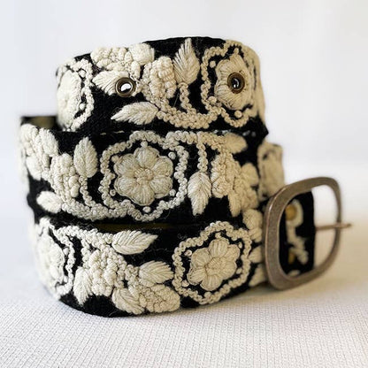 Black belt with white floral embroidery.