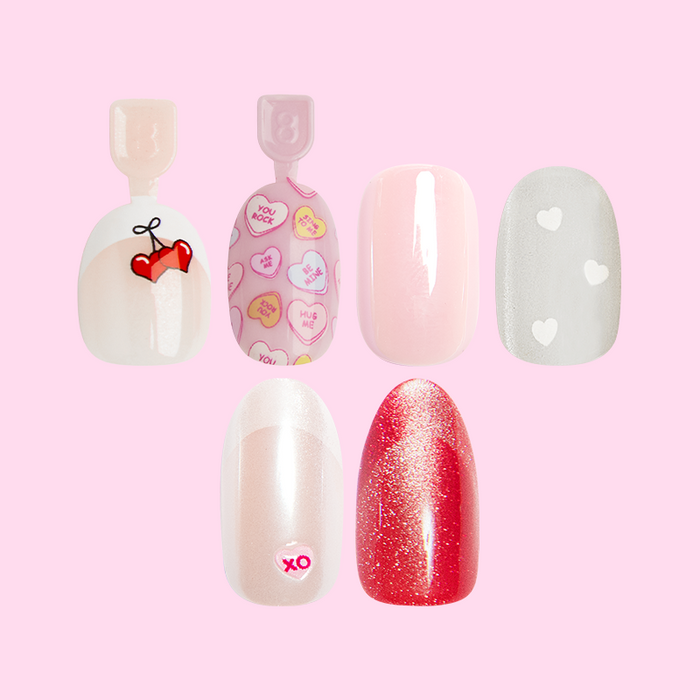 Valentine’s Day Press-on Set (Instant Mani + Super Stick + Pressies) featuring five festive false nails with hearts and glitter designs