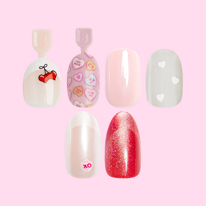 Valentine’s Day Press-on Set (Instant Mani + Super Stick + Pressies) featuring five festive false nails with hearts and glitter designs
