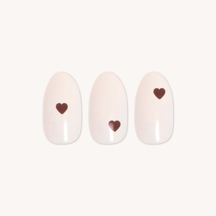 Vampy Heart - Press-On | Medium | Oval showing medium oval false nails with subtle pale polish and small red heart detail design