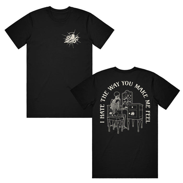 image of the front and back of a black tee shirt on a white background. front of tee is on the left and has a small right chest print of a bird. the back of the tee is on the right and has a print of a person looking in a broken mirror of a vanity. arched around says i hate the way you make me feel.