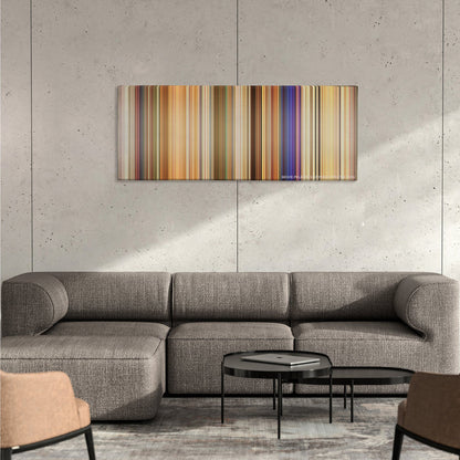White Chicks color palette canvas on a concrete wall above a gray sectional sofa