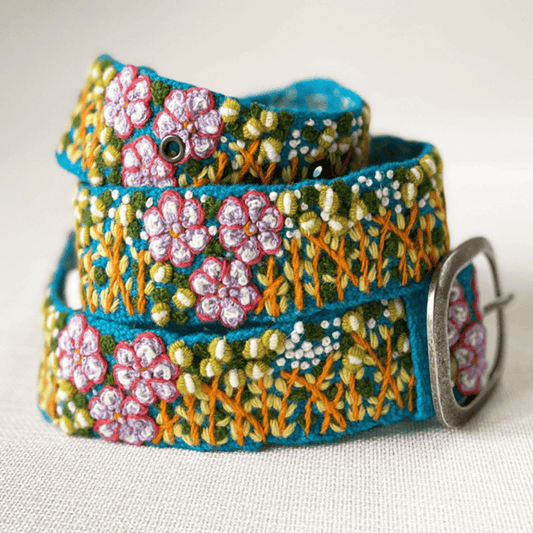 Embroidered blue belt with floral design.
