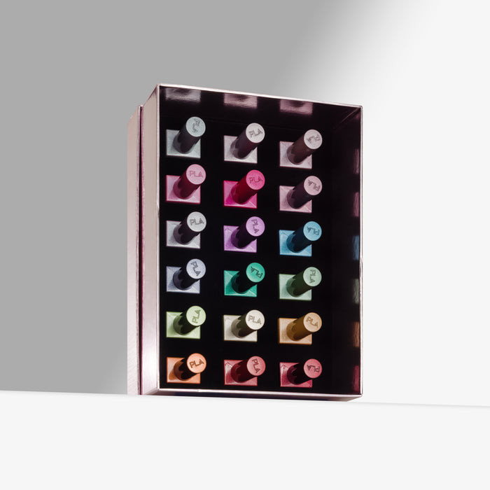A rectangular open box containing multiple cat eye gel nail polishes arranged in a grid, photographed on a clean light gray studio background. The polishes show assorted shades including pink, blue, green, purple, and orange